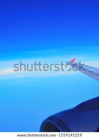 Beautiful sky​ view through the aircraft window. Clouds and sky as seen through window of an aircraft