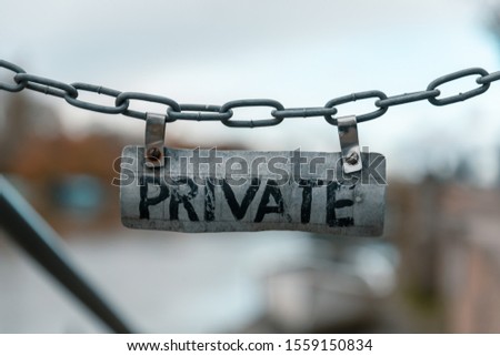 Metal chain sign wrote Privet on it. 