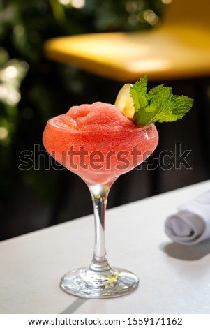 Fresh alcohol cocktail or lemonade beverage outside of restaurant in a summer day