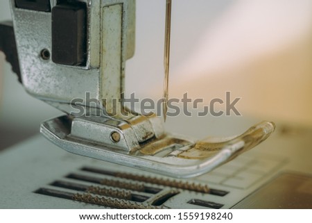 Closeup the sewing machine and needle with out sewing thread, selective focus. Royalty high-quality close up stock photo image of a needle with out sewing thread in sewing machine