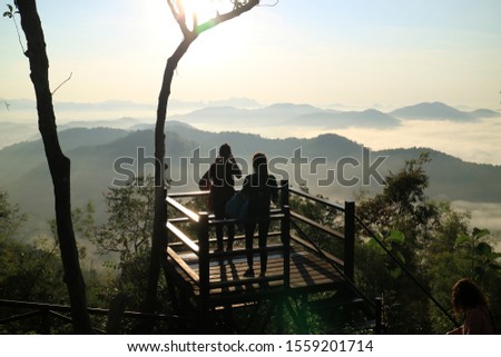 Tourists enjoy the view of the sea of ​​mist in the winter at Phu Bo Bid, Loei Province, Thailand.