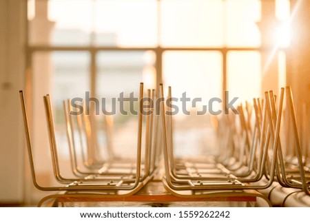 Chair group on table in classroom on morning, education concept furniture, empty people student in room, seat and desk in school or university on blurred window and sunny light beauty