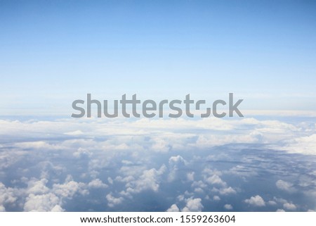 Beautiful, dramatic clouds and sky viewed from the plane.  Royalty-Free Stock Photo #1559263604