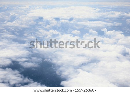 Beautiful, dramatic clouds and sky viewed from the plane.  Royalty-Free Stock Photo #1559263607
