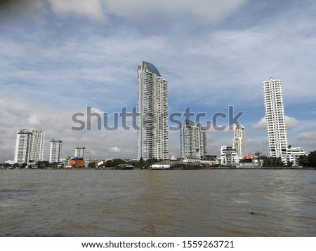 Pictures of high-rise buildings, condominiums, and cottages that are constructed together as a community. Beside the Chao Phraya river Indicating prosperity In Bangkok, Thailand