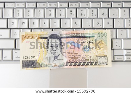 Philippine money on computer keyboard