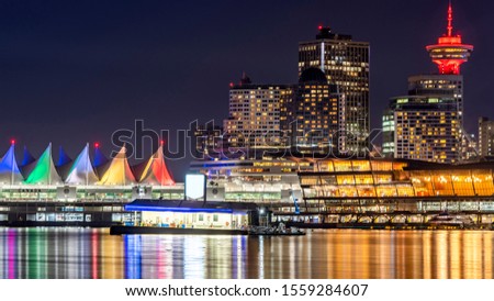 Vancouver, British Columbia, Canada.  Panorama cityscape at night, Illuminated buildings against deep blue sky.