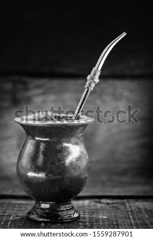 A typical Brazilian drink, o chimarrão, or mate, is a character, Black and white photography, drink in black and white. South American Tradition.