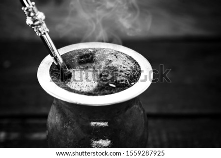 A typical Brazilian drink, o chimarrão, or mate, is a character, Black and white photography, drink in black and white. South American Tradition.