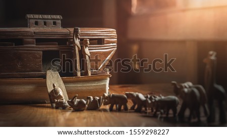 Noah's Ark with animals entering before great flood, story in Bible, Wood carving doll, christian concept. Royalty-Free Stock Photo #1559298227