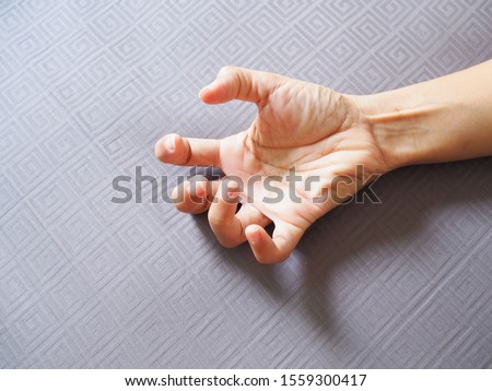 Hands with convulsions and muscle spasms, seizure disorder. Royalty-Free Stock Photo #1559300417