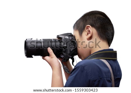 Asian boy holding digital camera isolated on white background