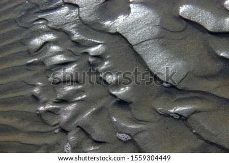 Raw sand. Dark background. Raw sand texture.