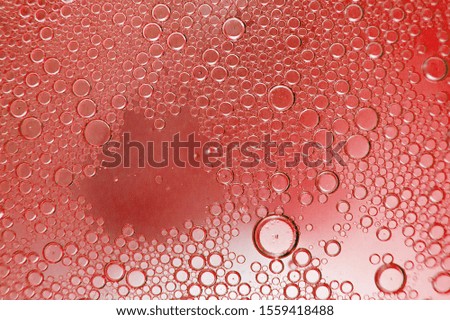 abstract light red background with oil circles .  bubbles of water close up . oil bubbles in the water macro.  circle bubbles  background