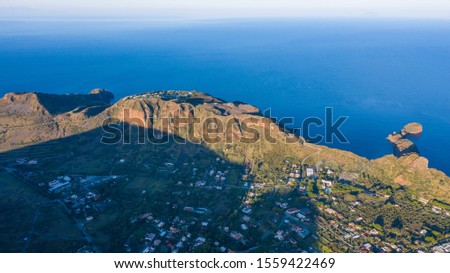 Aerial view photo from flying drone of Panoramic view from the volcano of Vulcano Island in a summer day. The islands of Lipari and Salina are visible in the distance, Aeolian Islands, Sicily, Italy. 