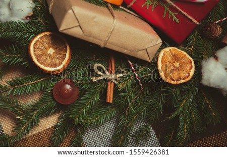 Handcrafted Christmas presents wrapped in decorative brown paper,shot on fir tree branches in close up