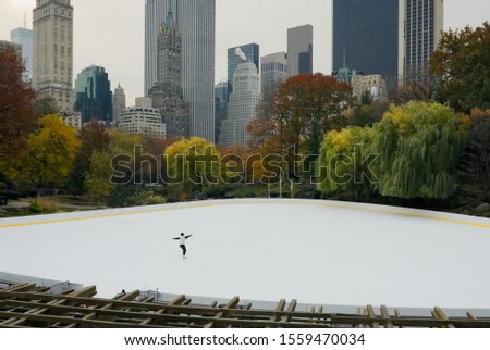 Girl skating alone on ice in Central Park, NYC.