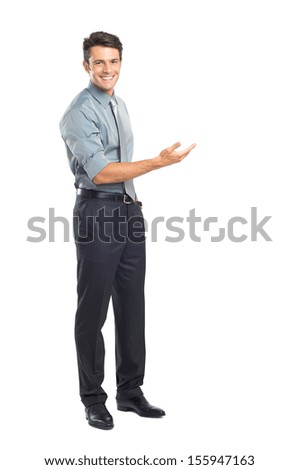 Happy Young Businessman Presenting Isolated Over White Background