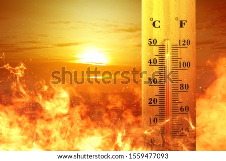 Thermometer with high temperature on the city with glowing sun background. Heatwave concept Royalty-Free Stock Photo #1559477093