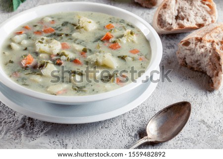 Vegetable soup with ingredients cauliflower,  carrot, potato and parsley on a plate
