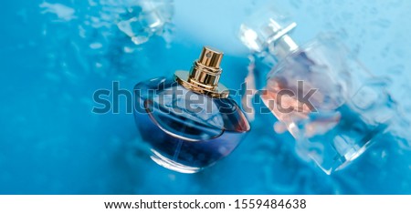 Perfumery, cosmetics and branding concept - Perfume bottle under blue water, fresh sea coastal scent as glamour fragrance and eau de parfum product as holiday gift, luxury beauty spa brand present Royalty-Free Stock Photo #1559484638