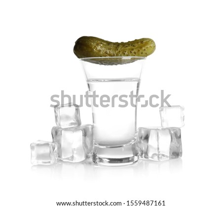 Russian vodka, pickle and ice cubes isolated on white