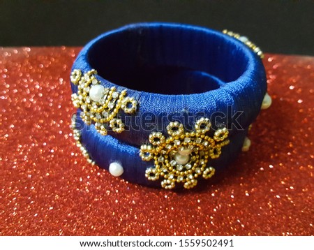 beautiful and fashionable bangles.fashionable crafts and bangles on color background