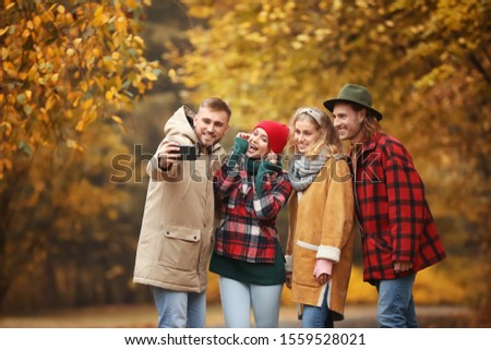 Friends taking selfie in autumn park