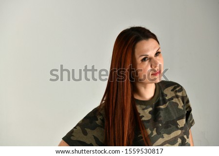 girl with red hair in uniform on a gray background