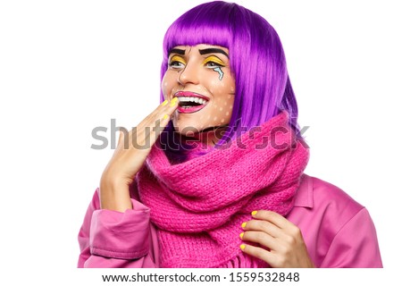 Model in creative image with pop art makeup on white background