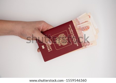 Hand holding stack of russian pasport roubles. Russia money five thousand banknote hold in hands. Royalty-Free Stock Photo #1559546360