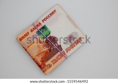 Russian banknotes folded in half with an elastic band