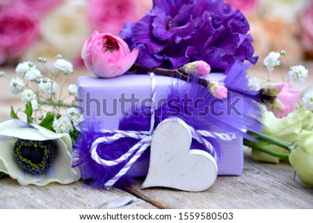 Small beautiful gift box with heart and spring flowers. Bouquet. Greeting card for Mother's Day, birthday or wedding