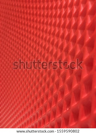 Abstract geometric pattern, rhombuses with indentations extending into the distance. Seamless background. Pink, red, raspberry texture. Graphic modern photo.