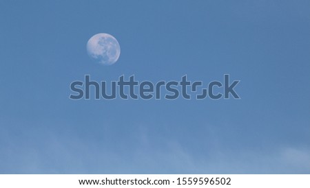 moon in the blue sky with clouds