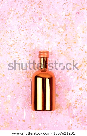 Festive shiny bottle. Abstract photo with a bottle of wine and sequins. Bright spectacular picture.
