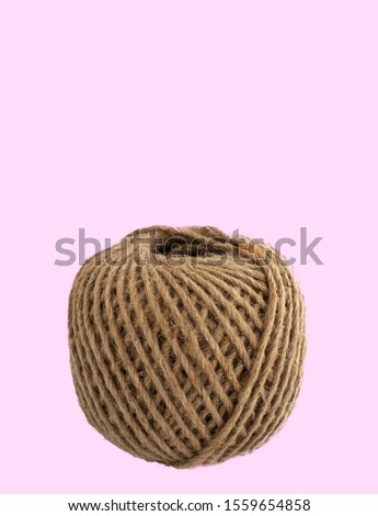 Bundle of hemp rope isolated on pink background. Hemp rope is a natural material for handcraft or handwork. A natural fiber material is old but eco-friendly. AKA, manila fiber. Eco packaging concept.