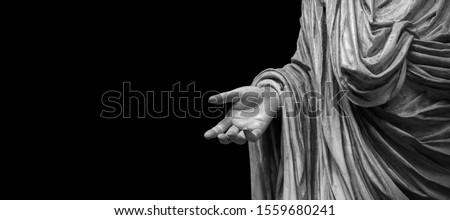 Man hand on antique tunic. Stone statue detail of human hand. Folds in the fabric. Copyspace for text