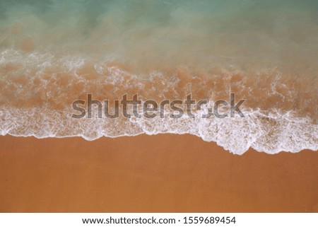 Coastline Beach Ocean waves with foam on the sand. Top view