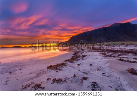 The beach of farstad at sunrise beautiful colors doinating this landscape.