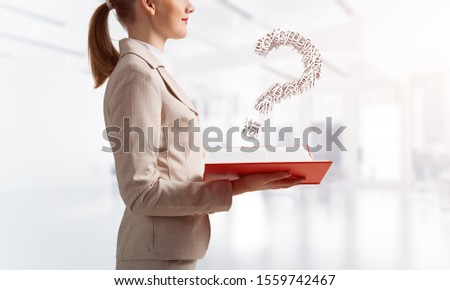 Attractive woman holding open notebook with question mark from letters. Business consultation and legal assistance. Elegant woman in business suit with open book in hands on background of skyscape