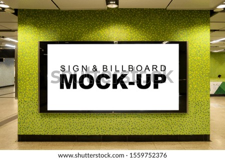 Mock up large blank horizontal billboard in metal frame with clipping path on the beautiful wall in walkway of building, empty space for insert advertising or media