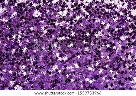Many purple glitter stars as a background