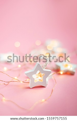 Merry Christmas and Happy Holidays  banner and greeting card. New Year. Wooden stars on a yellow christmas light bokeh background with copy space.Winter holiday theme.Wallpaper.