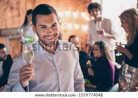 Happy holidays dear friends! Photo of group festive birthday party chatting handsome guy raising glass drink golden wine wear formalwear restaurant indoors
