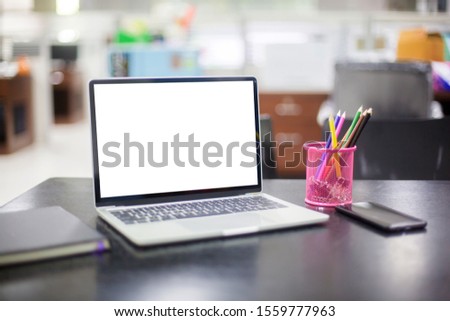 Computer laptop with white blank screen isolated  on work table in office.