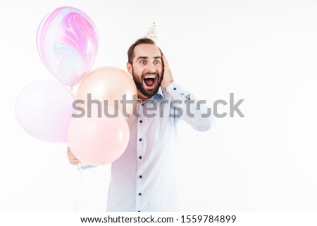 Image of caucasian party man screaming and holding air balloons isolated over white background