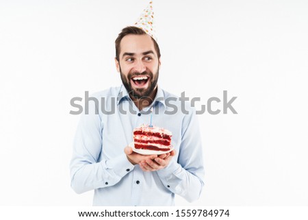 Image of masculine party man smiling and holding birthday cake with candle isolated over white background