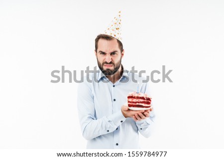 Image of excited party man smiling and holding birthday cake with candle isolated over white background