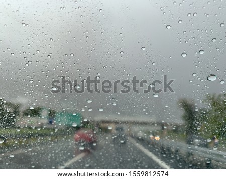 Waterdrop on the glass of car on raining day when driving